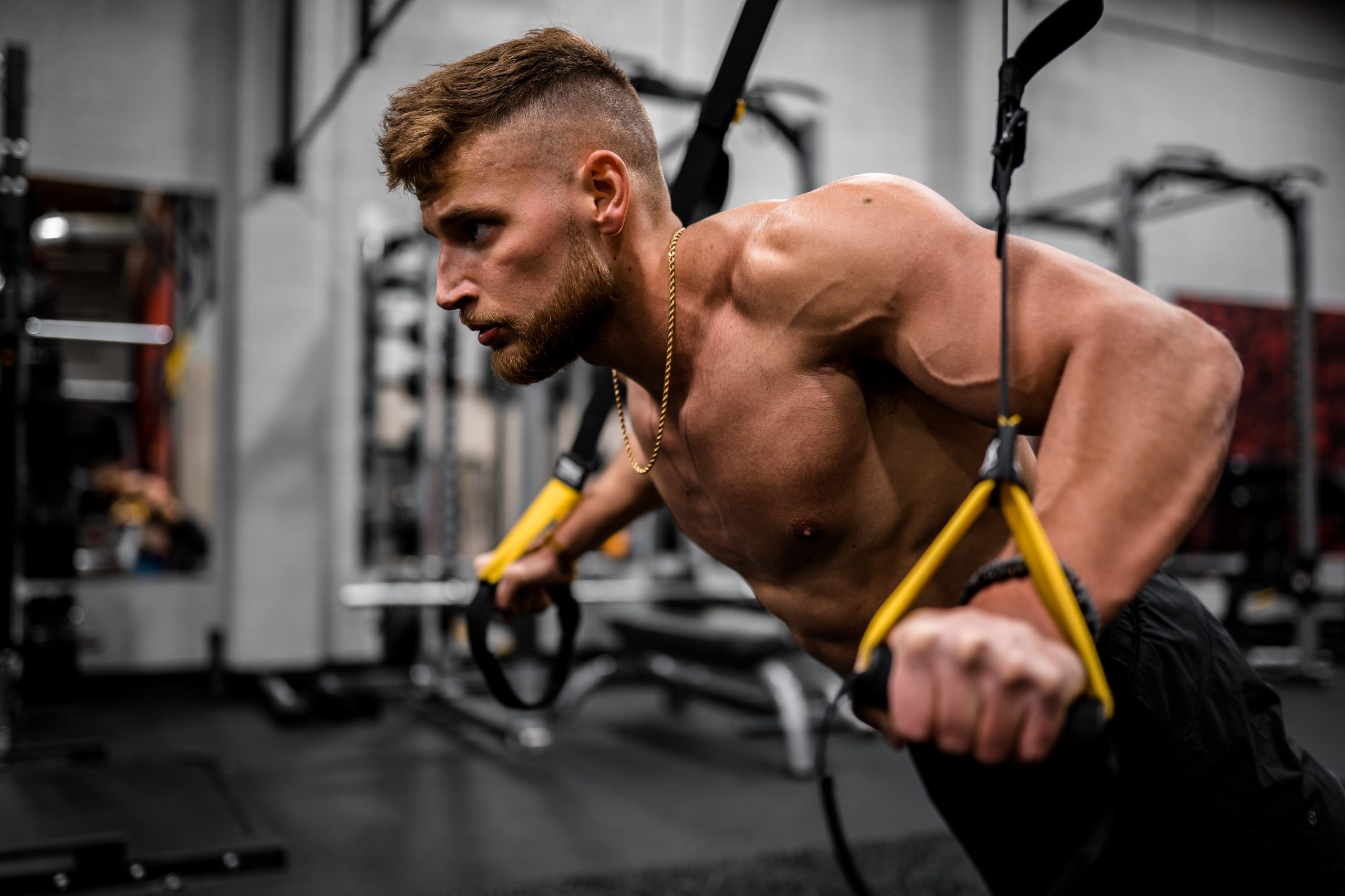 Sportif en pleine séance de TRX avec des sangles